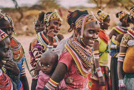 A group of happy African tribal people adorned with many colourful bead strands