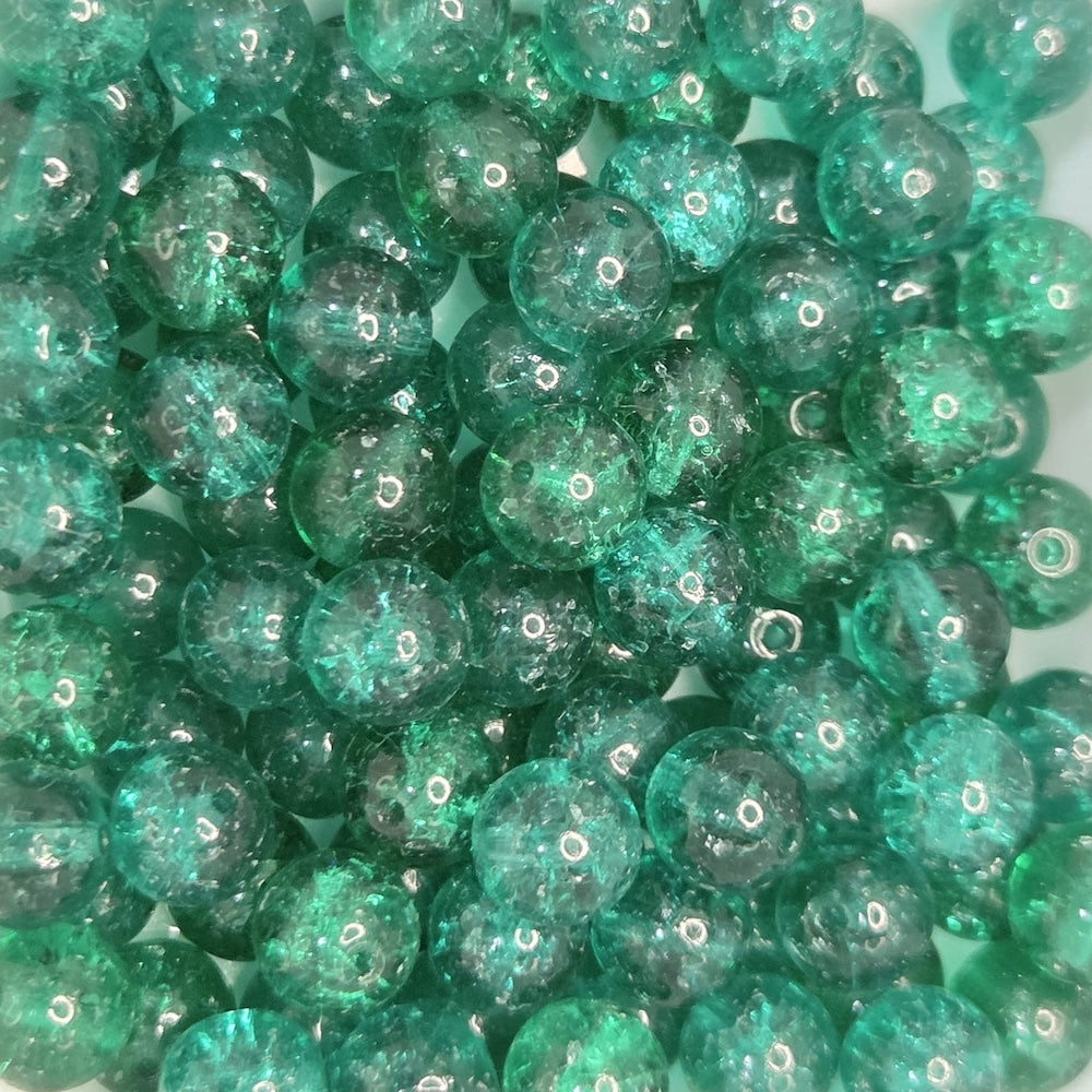 Green glittery beads on a white background