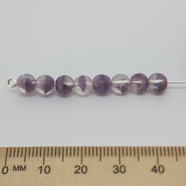purple givre transparent clear bead on a pin with a ruler for scale
