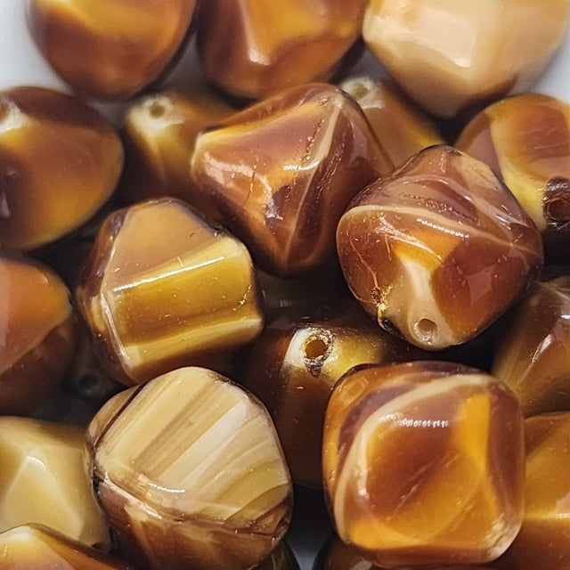 Close-up of amber-colored beads with a glossy finish