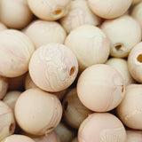 Close-up of marble finish wood look beads with a central hole.