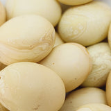 Close-up of marble finish wood look beads with a central hole.