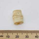 Bamboo look cream bead next to a ruler on a white background