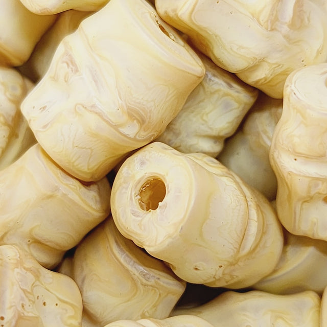 Close-up of marble finish wood look beads with a central hole.