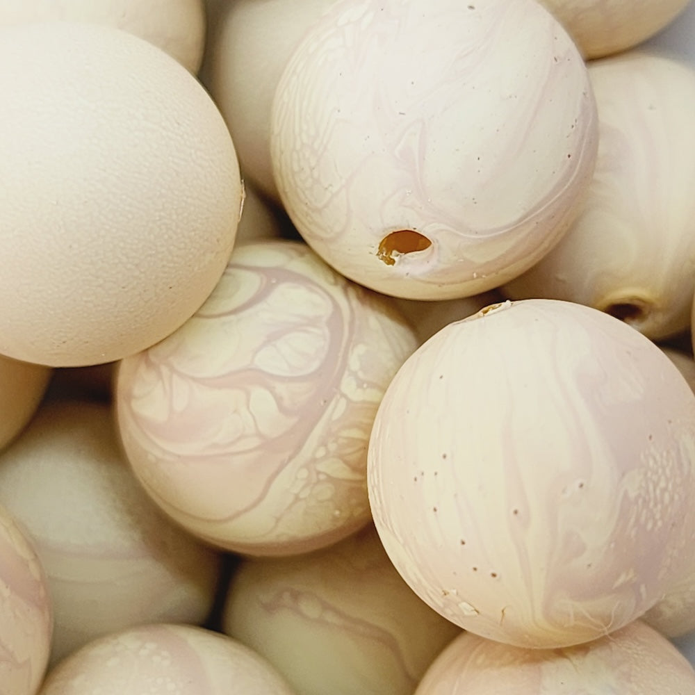 Close-up of marbled cream beads with a natural finish