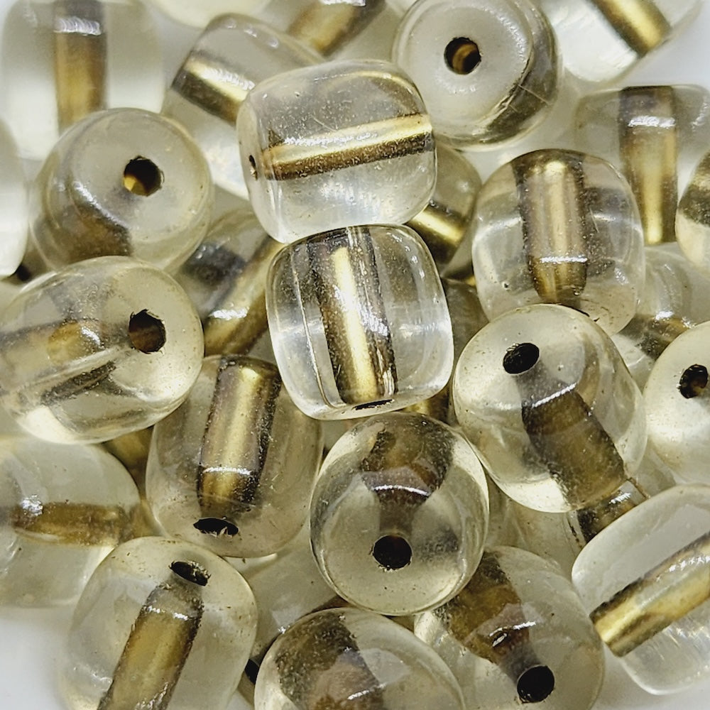 Close-up of clear beads with gold  green accents on a white background