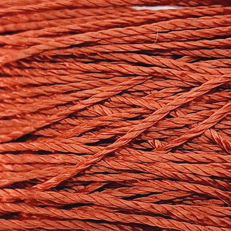 A close up photo of silky thread showing the textured surface used for the purpose of sewing craft and jewelry stringing