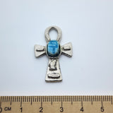 Metal Ankh vintage charm with turquoise blue tiny scarab beetle in the centre on a white background with a ruler for size perception