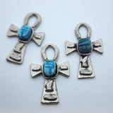 Three Metal Ankh vintage charms with turquoise blue tiny scarab beetle in the centre on a white background