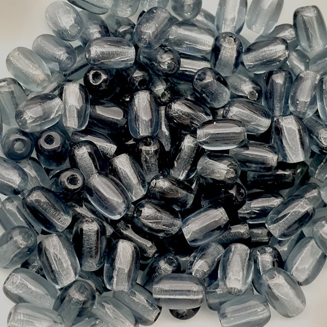 Close-up of deep blue cylindrical beads on a white background
