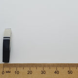 feather bead side on with a ruler for scale on a white background