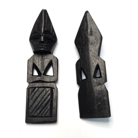 Two black wooden african folk art carvings on a white background