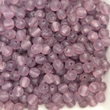 Close-up of purple beads on a white background