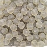 Close-up of translucent grey frosted beads on a white background