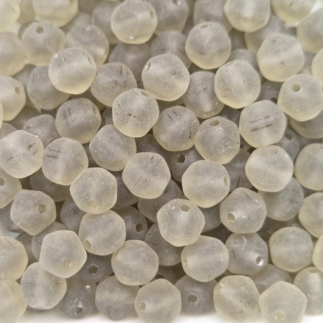 Close-up of translucent grey frosted beads on a white background