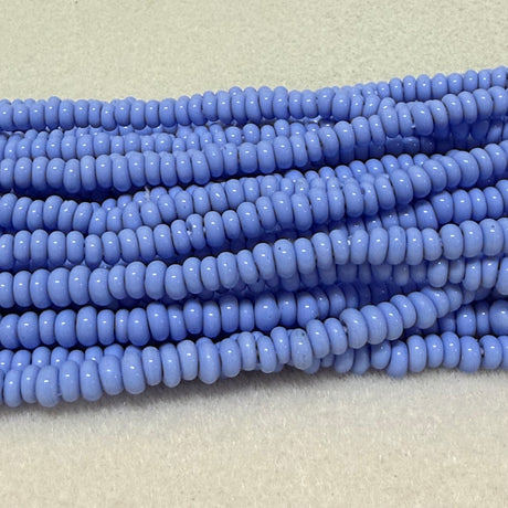 light blue donut shaped Indonesian glass bead strands on a white background