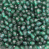 Close-up of green glass beads with a faceted texture.