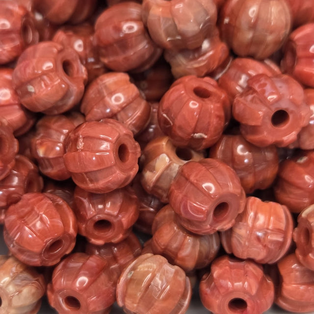 Close-up of red-orange beads with a textured surface
