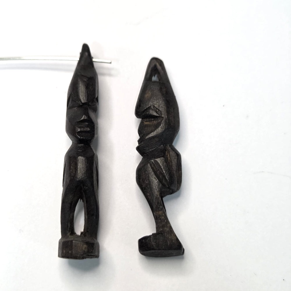 Two black african vintage wooden figures on a white background