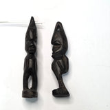 Two black african vintage wooden figures on a white background