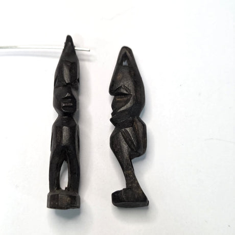 Two black african vintage wooden figures on a white background