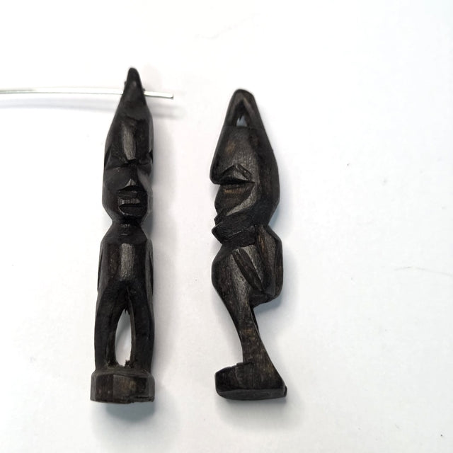 Two black african vintage wooden figures on a white background