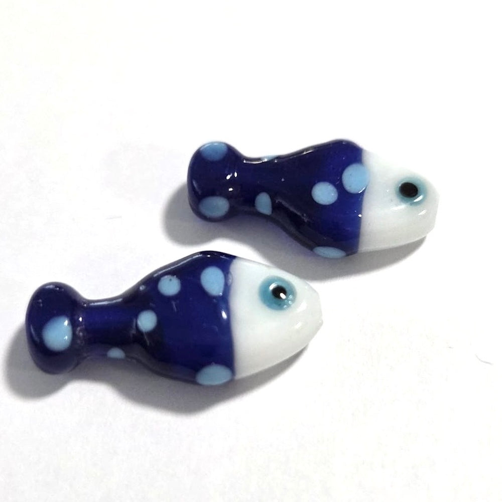 bright blue fish ceramic beads with light blue spots on a white surface