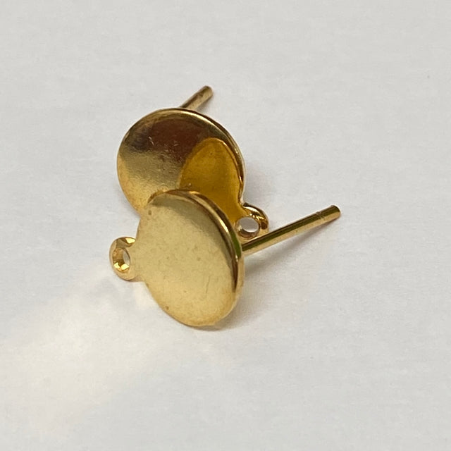 Gold stud earrings on a light gray background