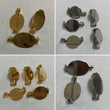 Gold and silver brooch making components on a white background