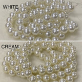 Two strands of pearls labeled 'White' and 'Cream' on a neutral background.