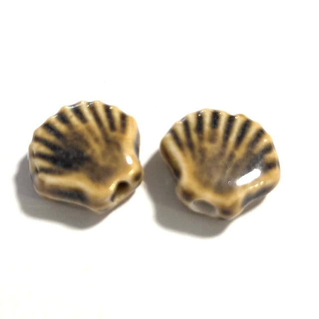 Two ceramic shell beads on a white background