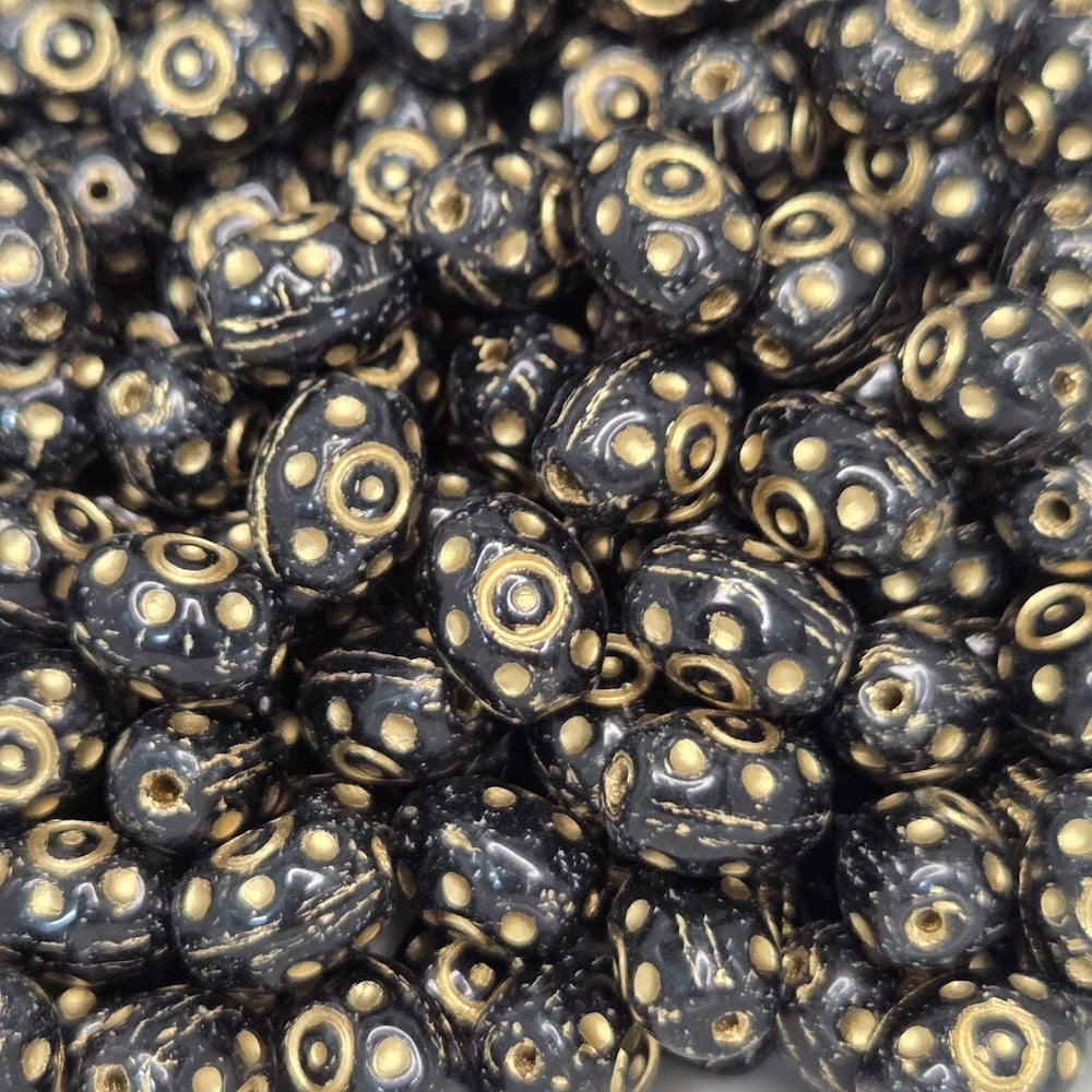 Close-up of black beads with gold patterns