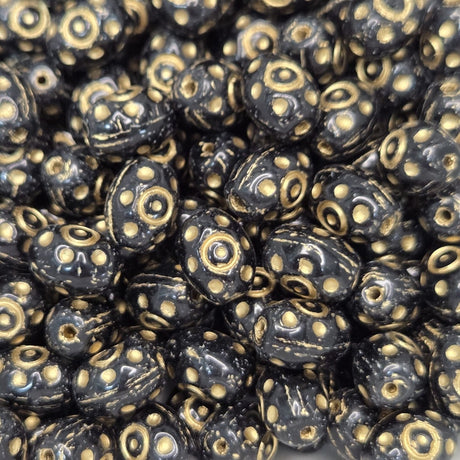 Close-up of black beads with gold patterns