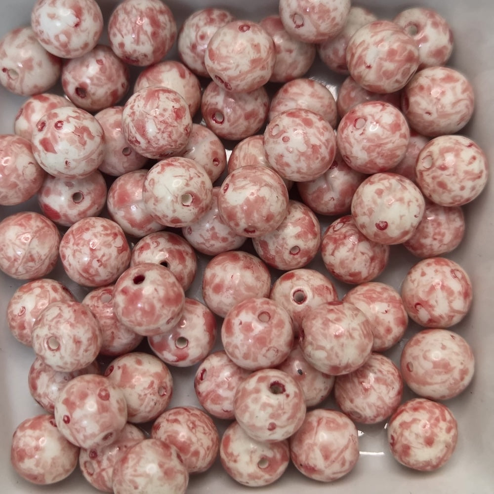 Marbled pink and white beads in a white container