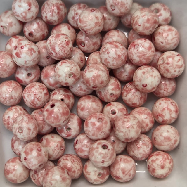 Marbled pink and white beads in a white container