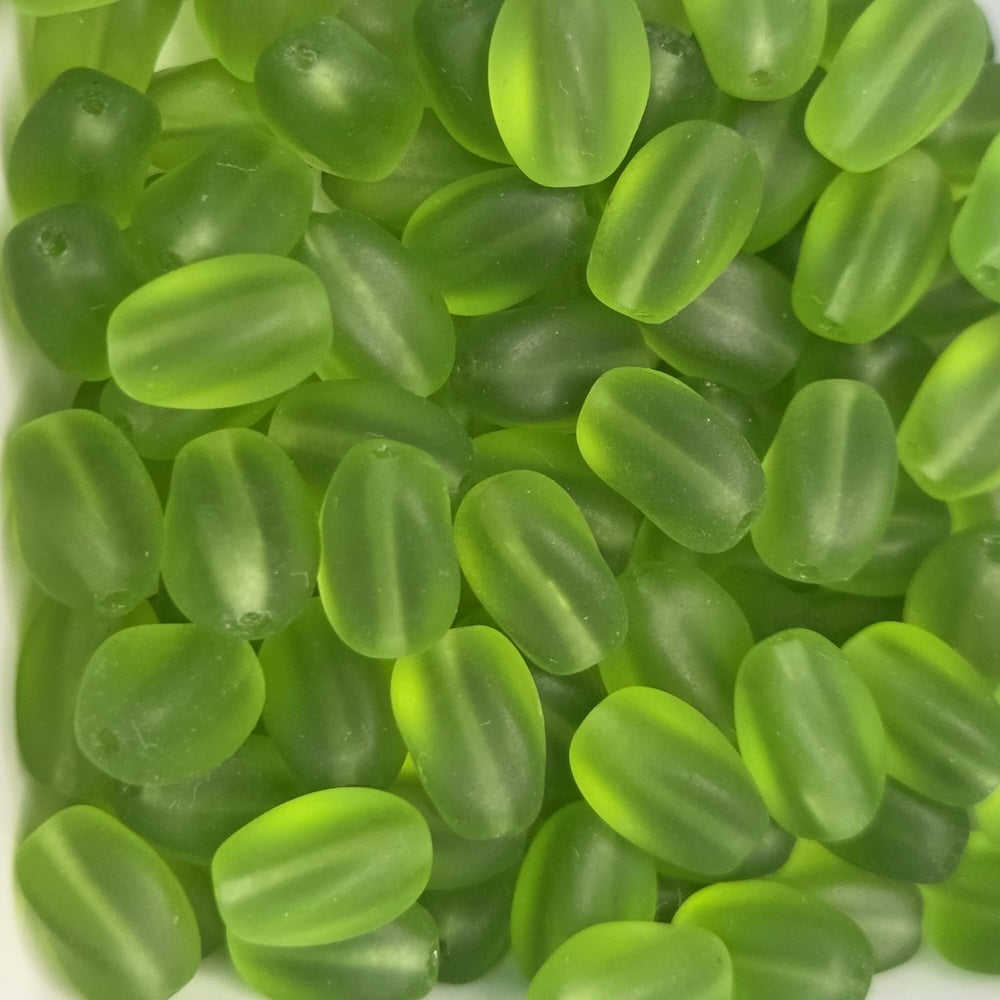 green frosted oval beads in a group showing threading holes for making jewelry
