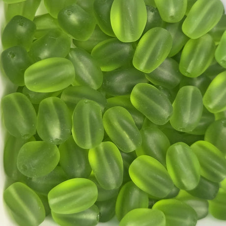 green frosted oval beads in a group showing threading holes for making jewelry