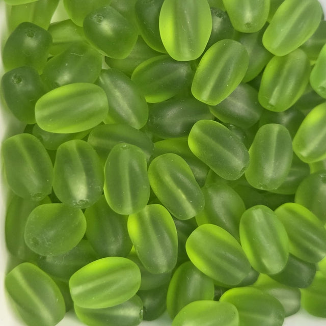 green frosted oval beads in a group showing threading holes for making jewelry