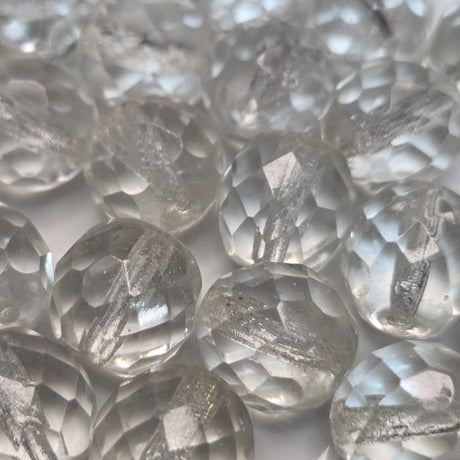 Close-up of clear faceted firepolish beads with on a white background