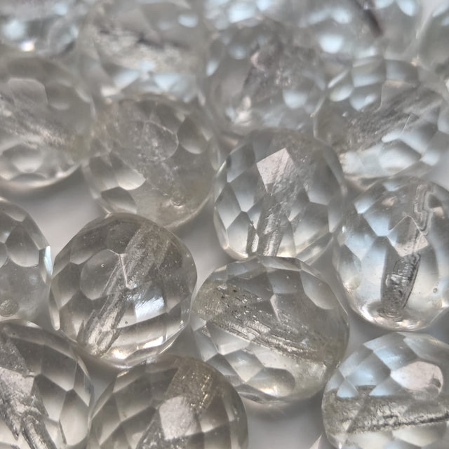 Close-up of clear faceted firepolish beads with on a white background
