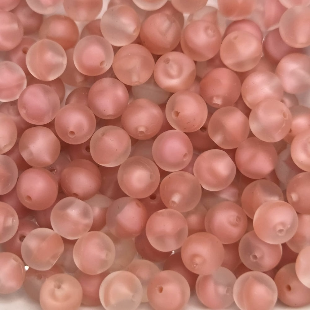 Close-up of pink beads on a white background