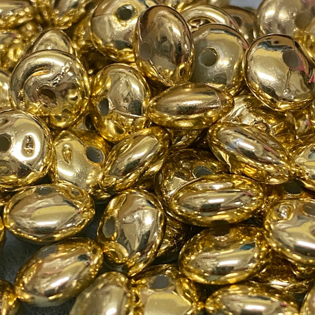 Close-up of gold beads with a metallic sheen.