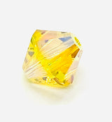 One yellow faceted crystal beads on a white background