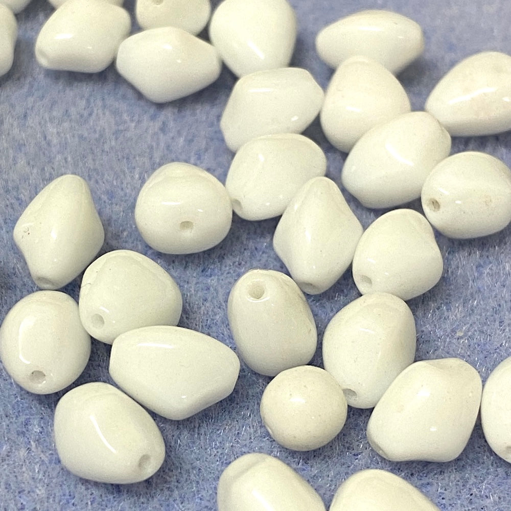 White beads on a textured blue surface