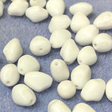 White beads on a textured blue surface