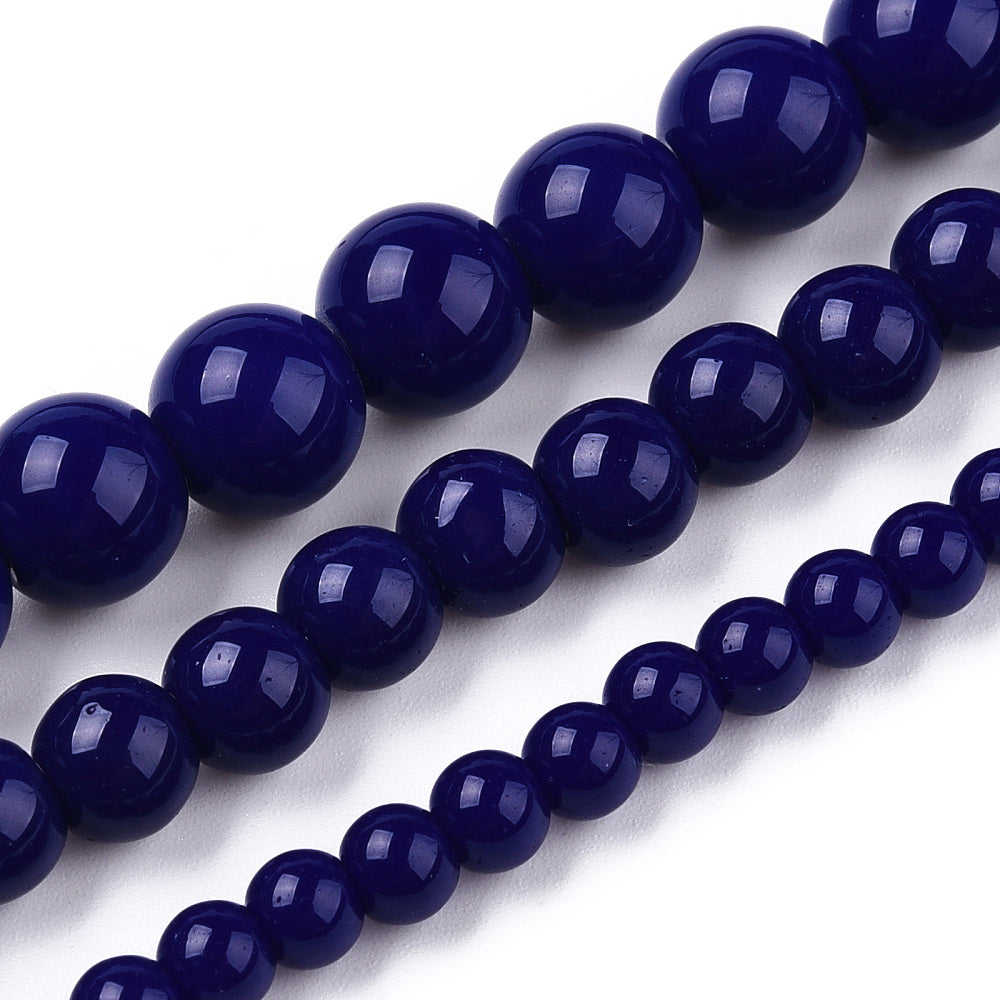 Close-up of dark blue beads on a white background