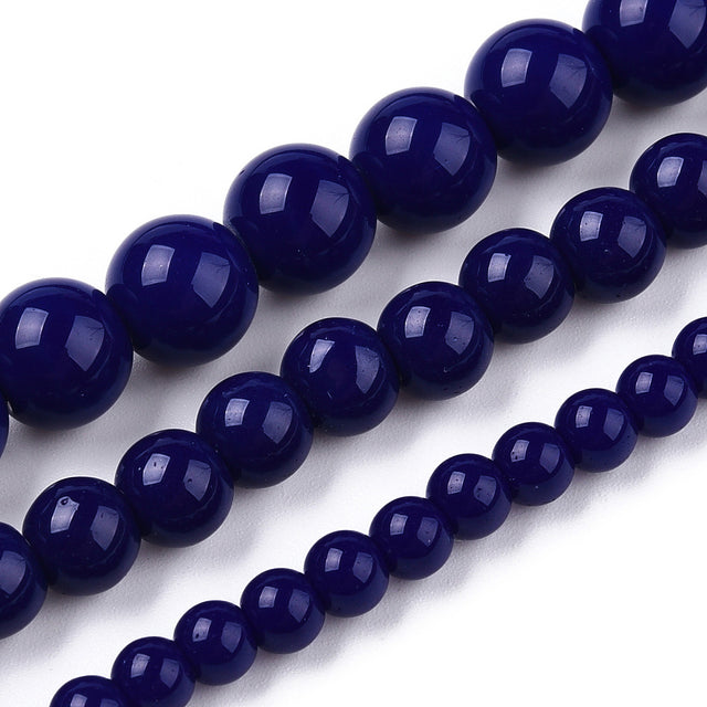 Close-up of dark blue beads on a white background