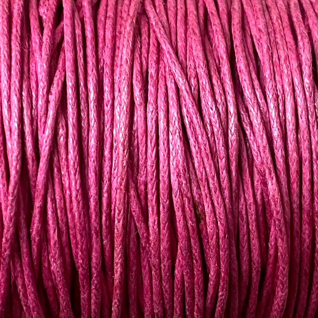 Close-up of dark pink wax cotton strands