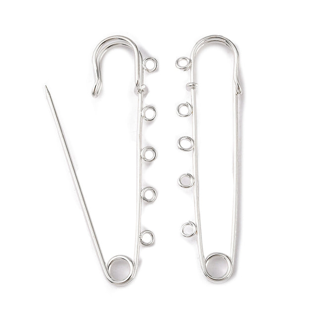 A 75mm long silver-colored kilt pin with multiple loops and a hole at the top for attaching beads or fabric.