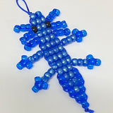 Blue beaded axolotl toy on a white background